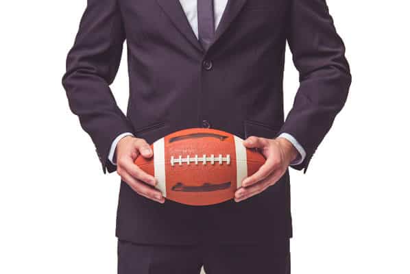 businessman holding football